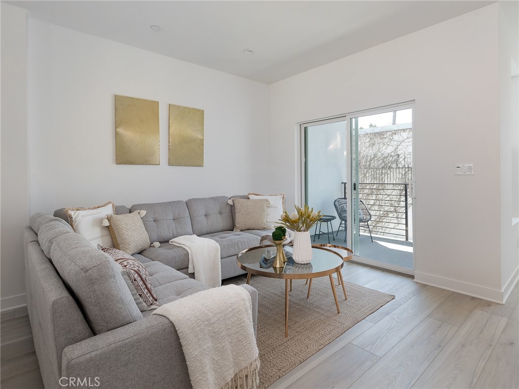 121 East 223rd Street, Unit 3 Carson, CA 90745 - Photo 12 of 34 a living room with furniture and wooden floor