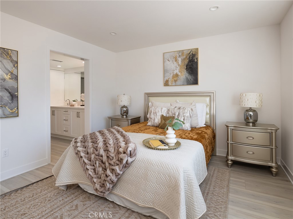 121 East 223rd Street, Unit 3 Carson, CA 90745 - Photo 16 of 34 a bedroom with a bed and a chandelier