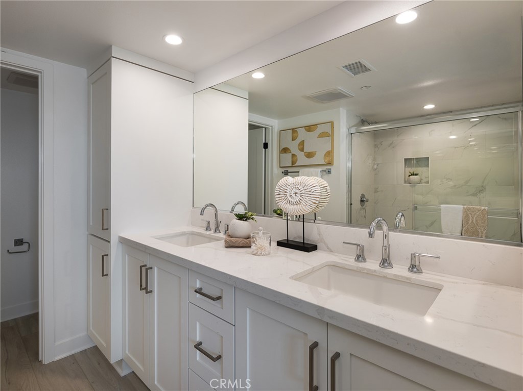 121 East 223rd Street, Unit 3 Carson, CA 90745 - Photo 17 of 34 a bathroom with double sink and a mirror
