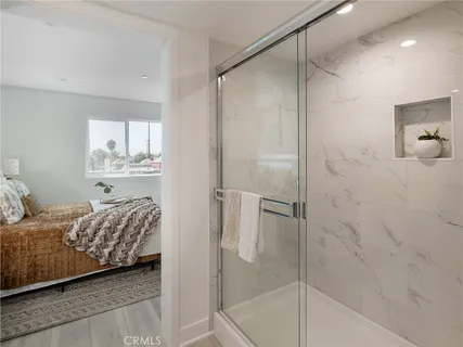 a bedroom with bed and a potted plant