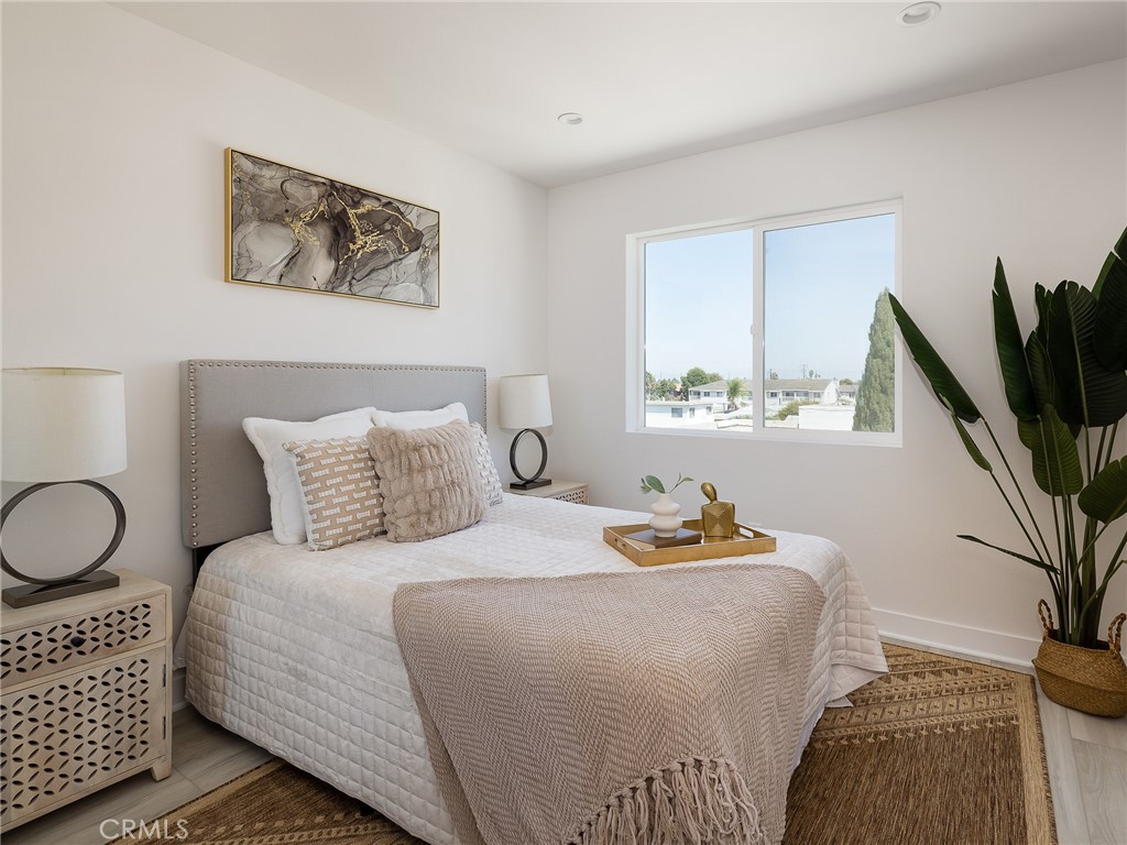 121 East 223rd Street, Unit 3 Carson, CA 90745 - Photo 20 of 34 a bedroom with bed and a potted plant
