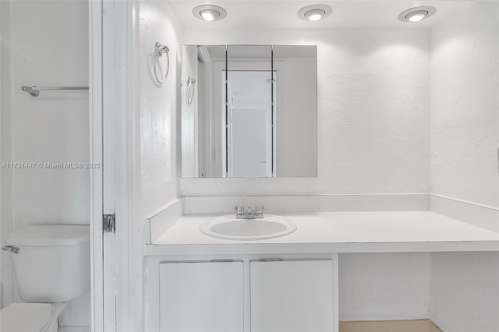 6884 North Kendall Drive, Unit C404 Pinecrest, FL 33156 - Photo 12 of 21 a bathroom with a sink and a mirror