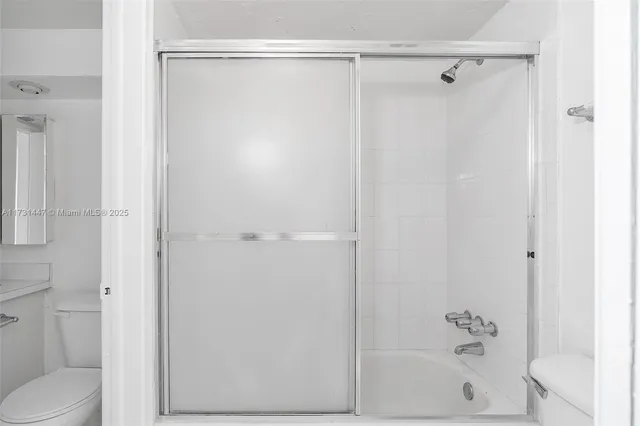 a bathroom with a shower and a toilet