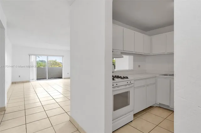 a kitchen with a stove top oven and cabinets