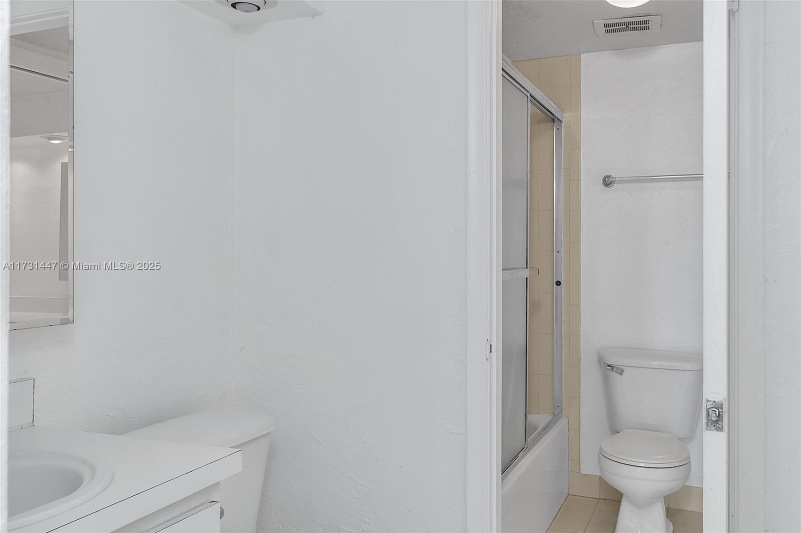 6884 North Kendall Drive, Unit C404 Pinecrest, FL 33156 - Photo 9 of 21 a bathroom with a granite countertop toilet and a sink