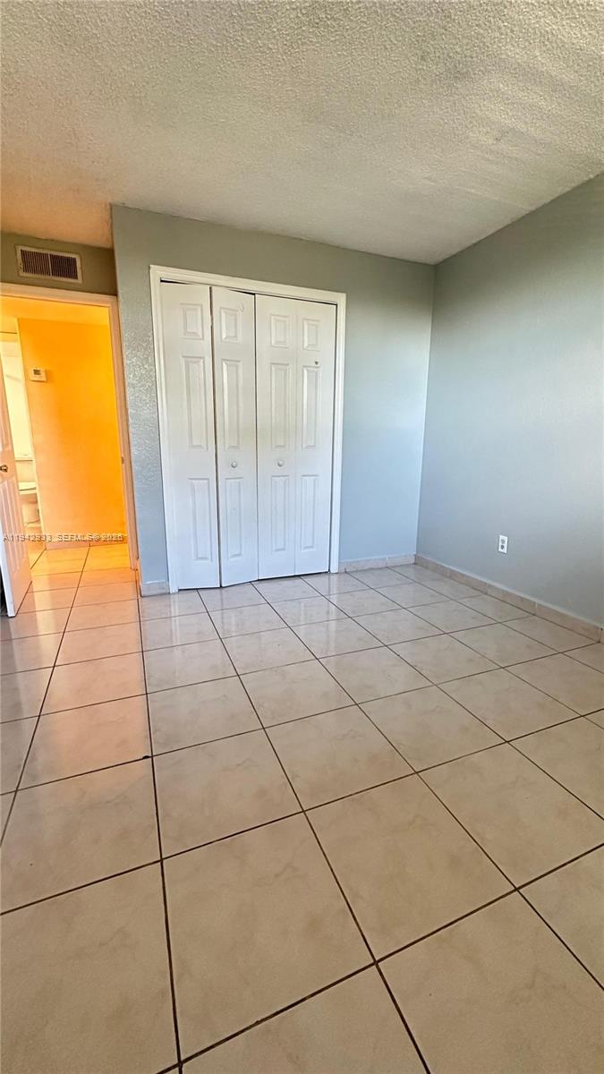 606 West 81st Street, Unit 305 Hialeah, FL 33014 - Photo 11 of 11 a view of a livingroom with an empty space and a window