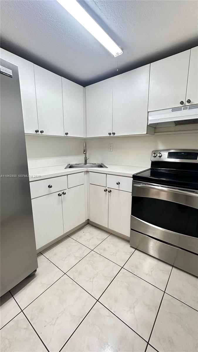 606 West 81st Street, Unit 305 Hialeah, FL 33014 - Photo 2 of 11 a kitchen with cabinets and appliances