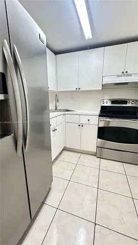 a kitchen with cabinets and steel stainless steel appliances