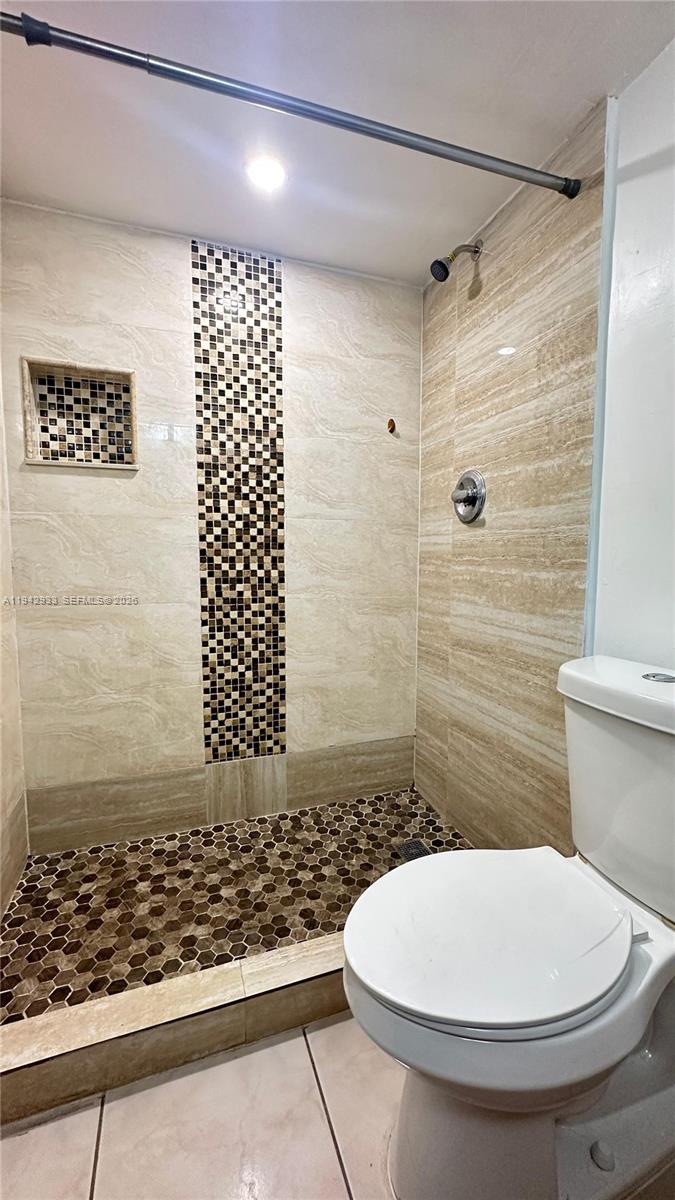 606 West 81st Street, Unit 305 Hialeah, FL 33014 - Photo 7 of 11 a bathroom with a toilet and a shower