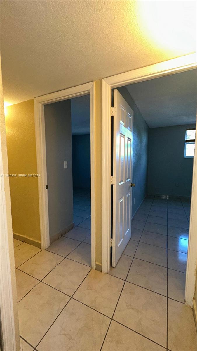 606 West 81st Street, Unit 305 Hialeah, FL 33014 - Photo 9 of 11 a view of a refrigerator in kitchen and utility room