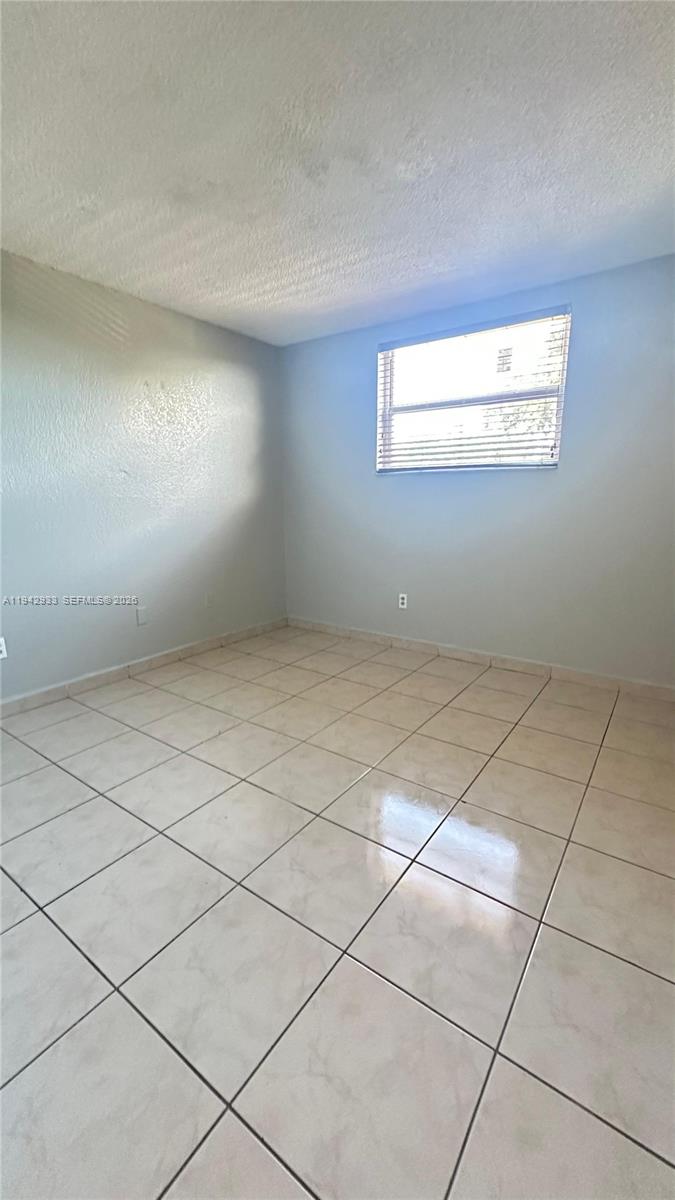 606 West 81st Street, Unit 305 Hialeah, FL 33014 - Photo 10 of 11 a view of an empty room and a window