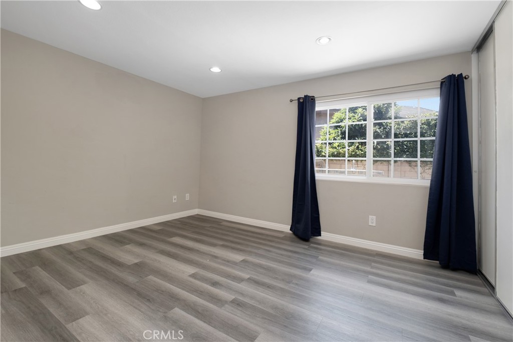 7 Hancock Irvine, CA 92620 - Photo 14 of 46 an empty room with wooden floor and windows