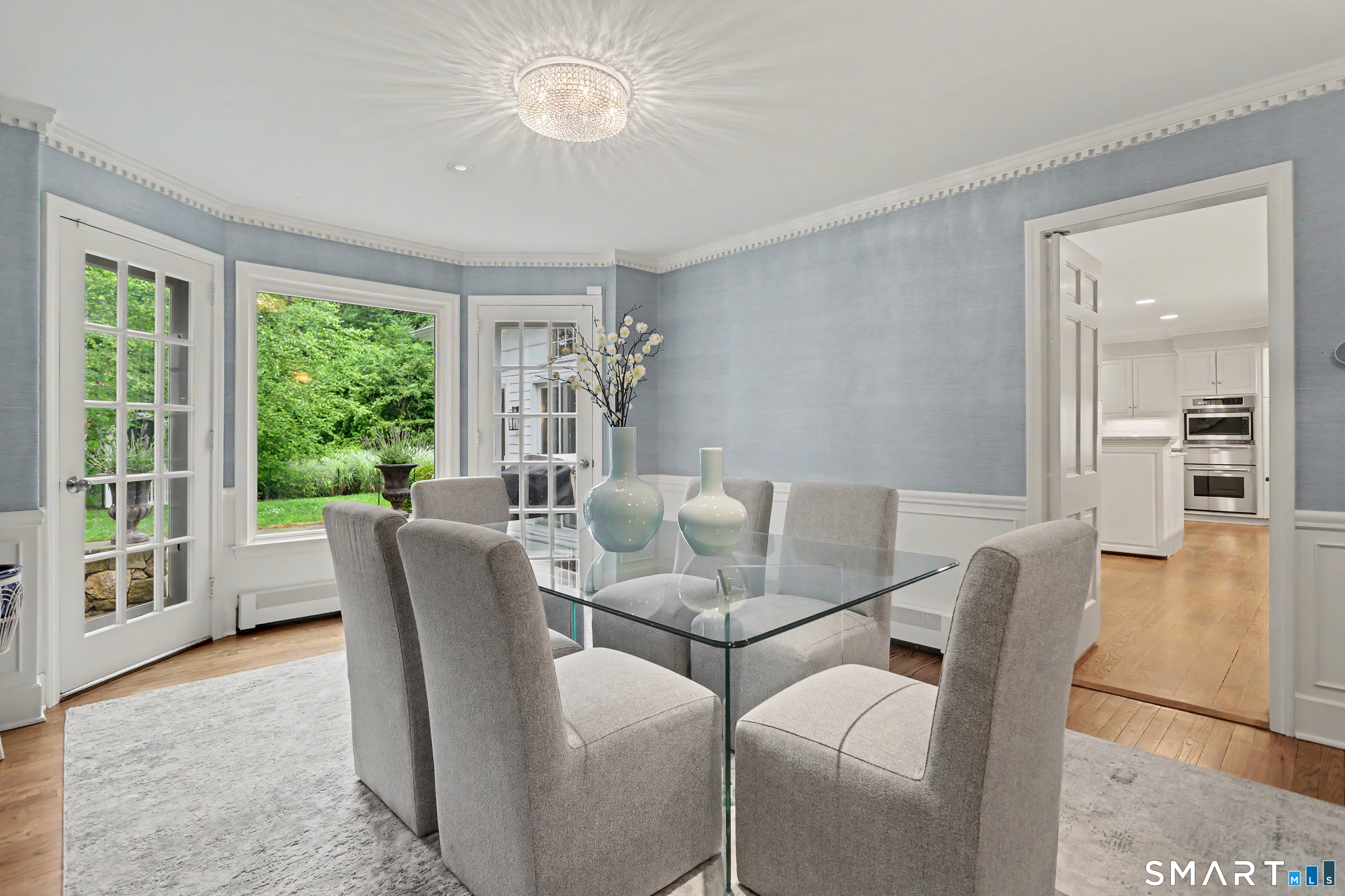 108 Logan Road New Canaan, CT 06840 - Photo 14 of 40 a dining room with furniture a chandelier and wooden floor