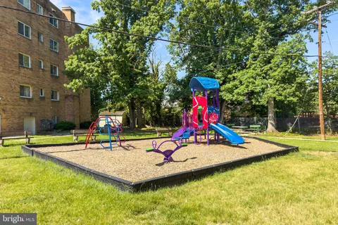 a view of park with slide and bench