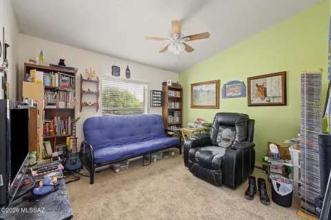 a living room with furniture and a bookshelf