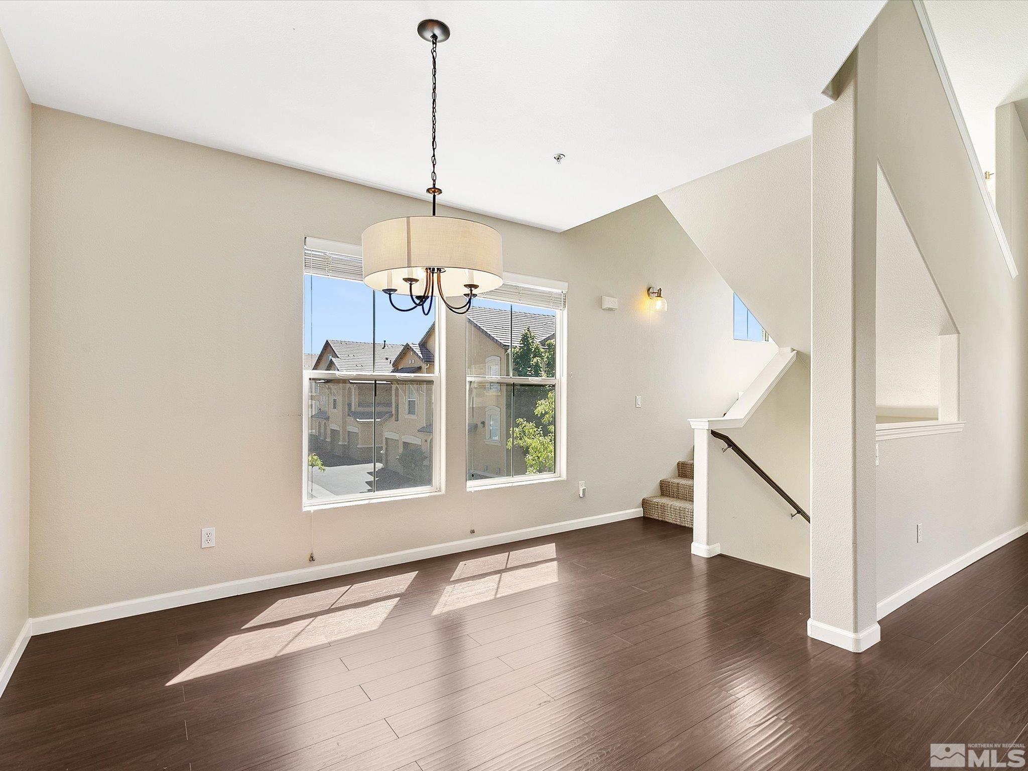 9050 Double R Boulevard, Unit 923 Reno, NV 89521 - Photo 8 of 10 a view of an empty room with wooden floor and a window