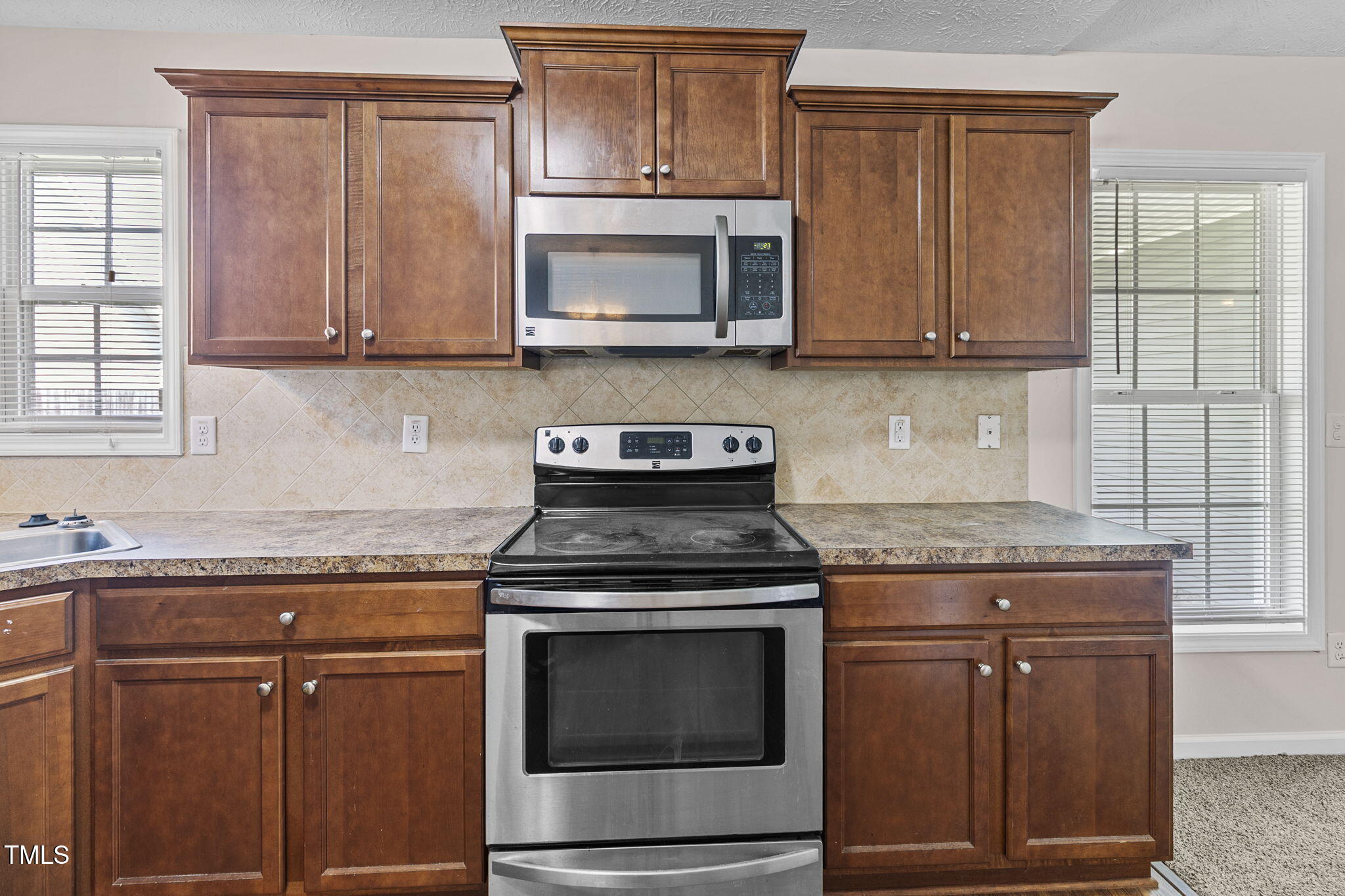2513 Hunting Bow Drive Hope Mills, NC 28348 - Photo 11 of 39 a kitchen with granite countertop cabinets stainless steel appliances and a sink