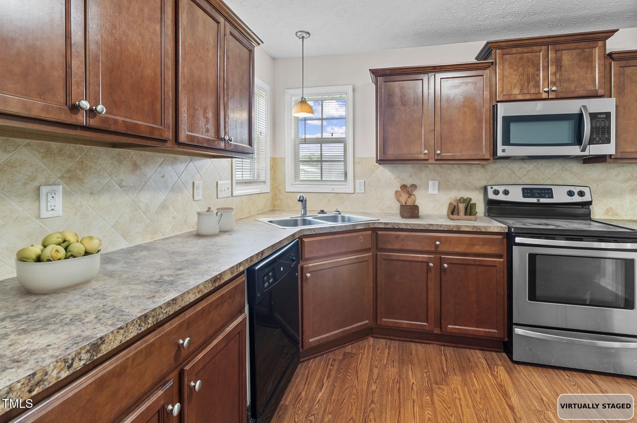 2513 Hunting Bow Drive Hope Mills, NC 28348 - Photo 12 of 39 a kitchen with stainless steel appliances granite countertop a sink stove and microwave