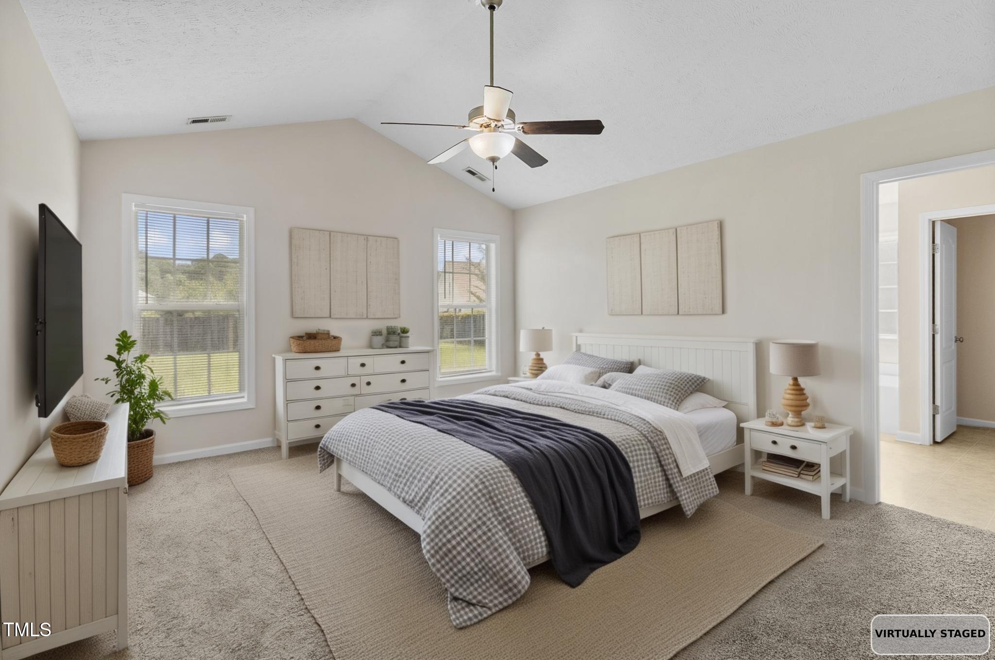 2513 Hunting Bow Drive Hope Mills, NC 28348 - Photo 17 of 39 a spacious bedroom with a bed and a chandelier