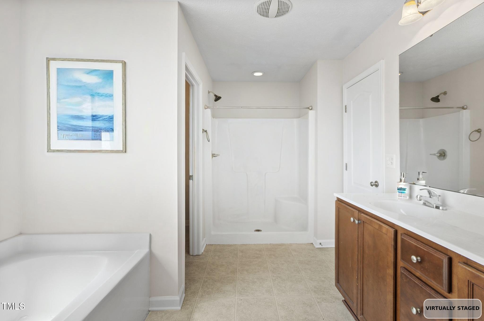 2513 Hunting Bow Drive Hope Mills, NC 28348 - Photo 25 of 39 a bathroom with a tub sink and mirror