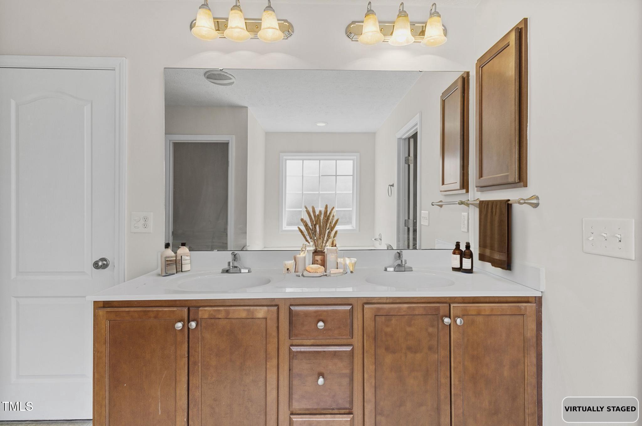 2513 Hunting Bow Drive Hope Mills, NC 28348 - Photo 27 of 39 a bathroom with a double vanity sink and a mirror