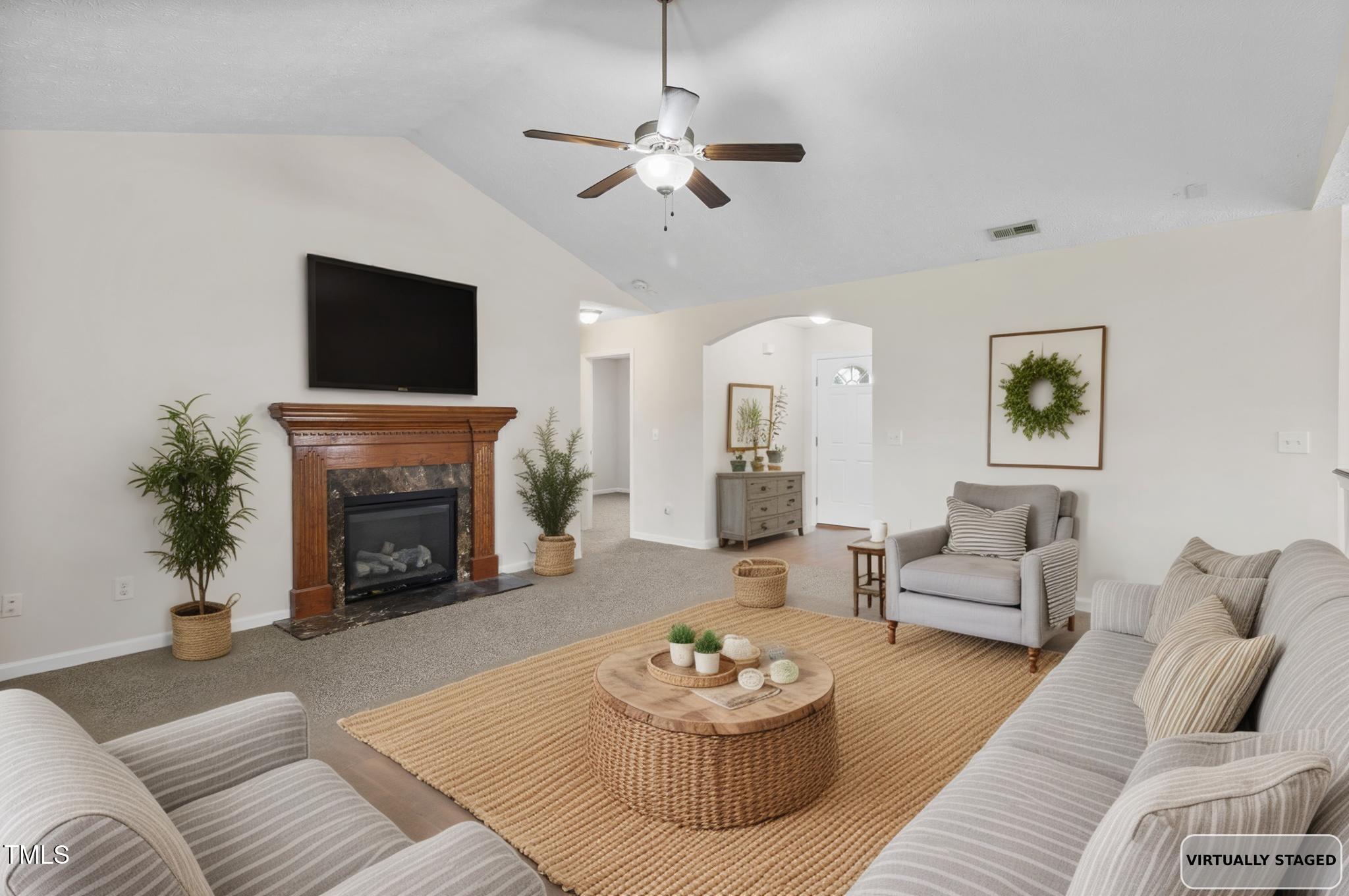 2513 Hunting Bow Drive Hope Mills, NC 28348 - Photo 4 of 39 a living room with furniture a fireplace and a flat screen tv