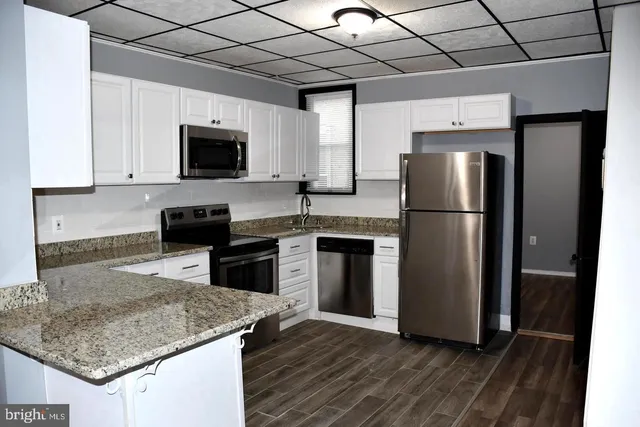 a kitchen with a refrigerator sink and microwave