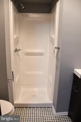 a bathroom with a glass door shower