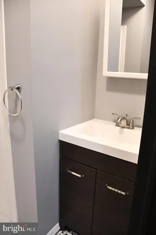 a bathroom with a sink and mirror