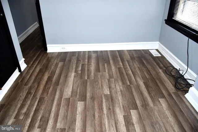 a view of wooden floor in a kitchen