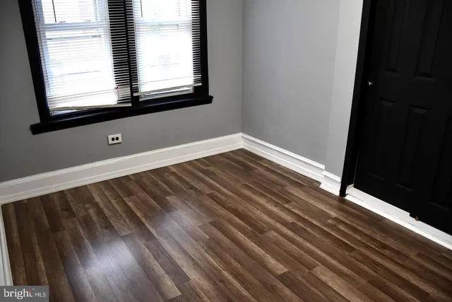 a view of wooden floor and windows in a room
