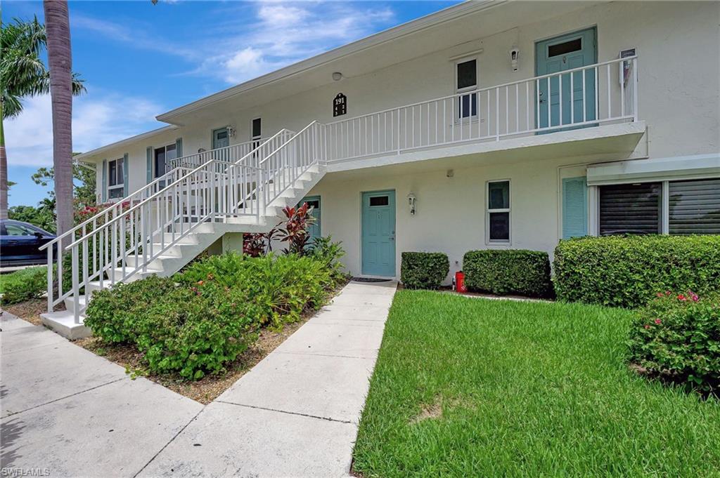 191 Quails Nest Road, Unit 1 Naples, FL 34112 - Photo 3 of 46 a front view of a house with a yard
