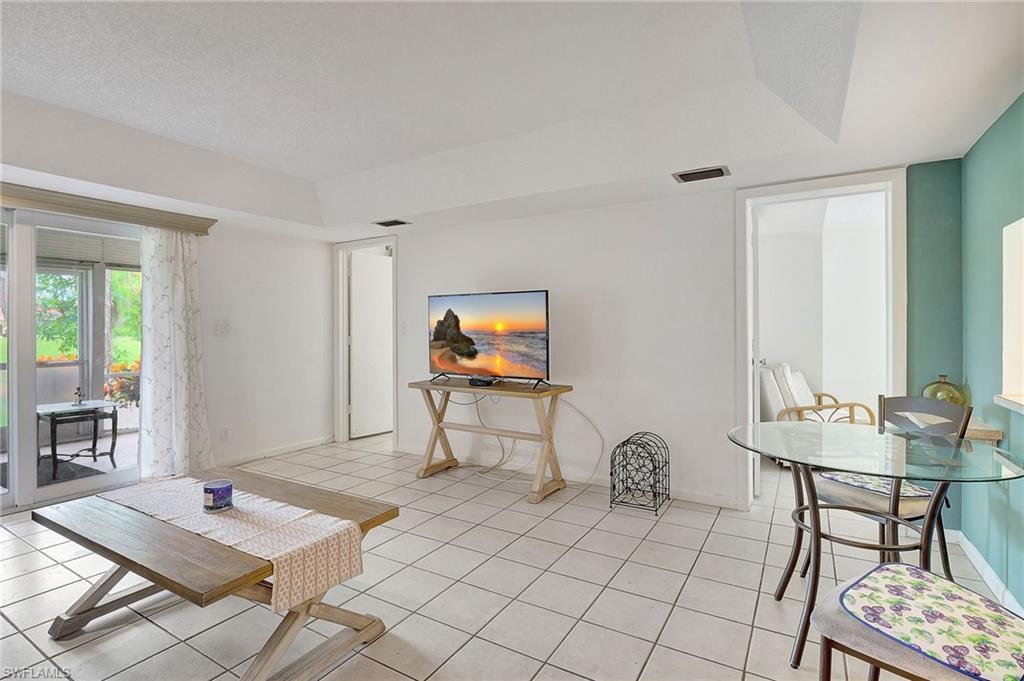 191 Quails Nest Road, Unit 1 Naples, FL 34112 - Photo 9 of 46 a living room with furniture a rug and a table
