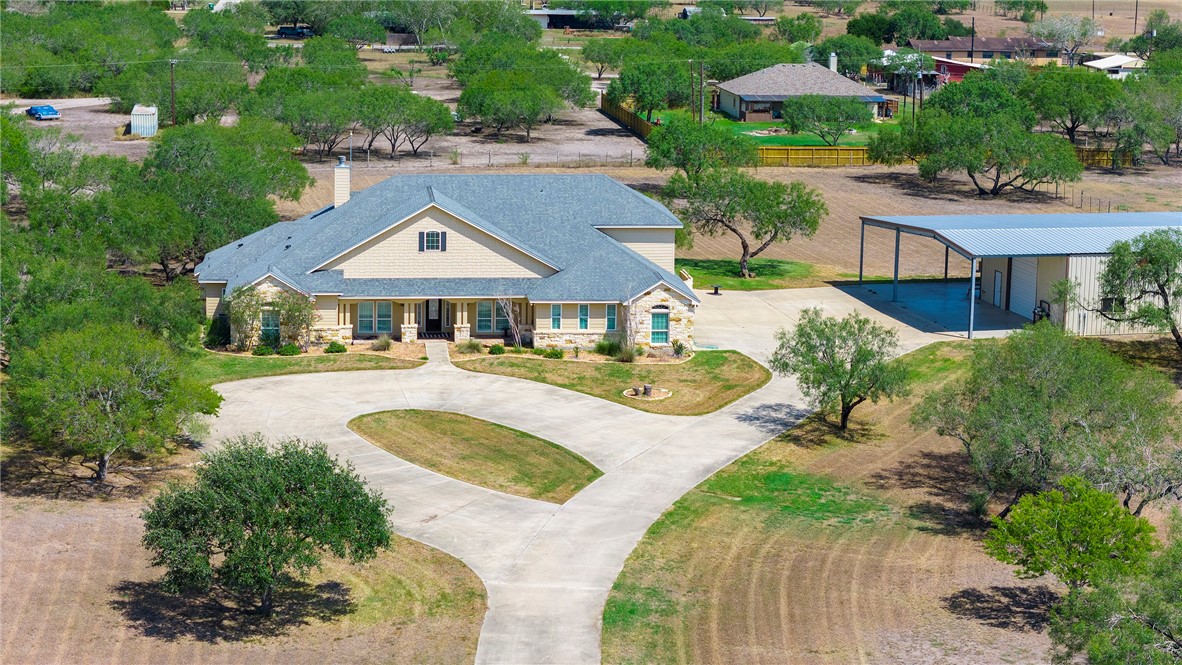 an aerial view of a house with swimming pool and garden