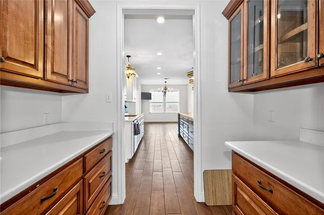 a view of a kitchen with wooden floor and cabinets