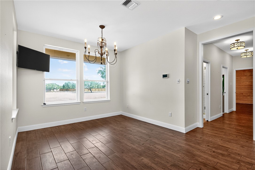 5332 Alegre Lane Robstown, TX 78380 - Photo 24 of 40 wooden floor in an empty room with a window