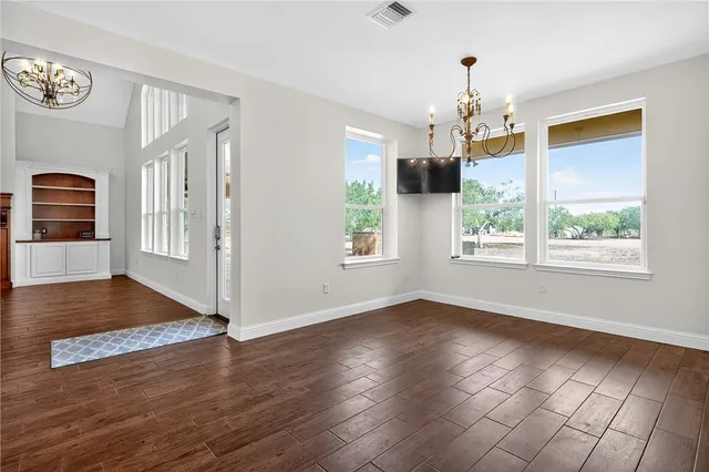 a view of a livingroom with wooden floor and a window