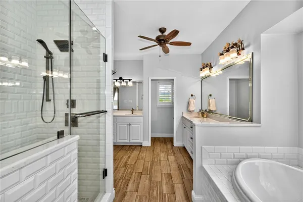 a bathroom with a sink a mirror and shower