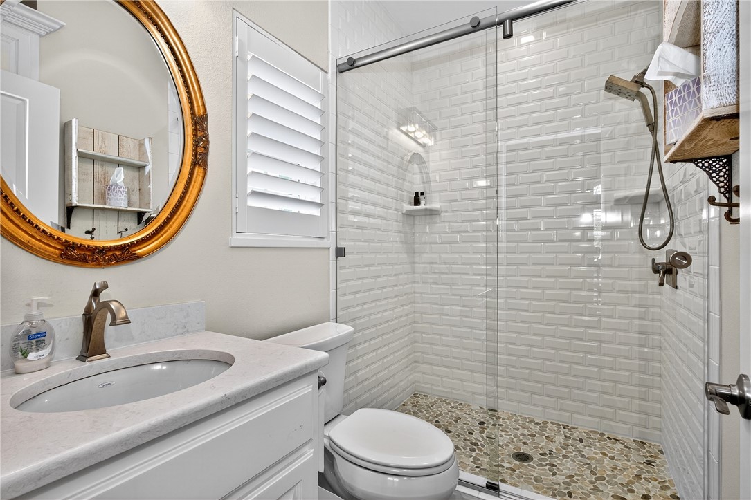 5332 Alegre Lane Robstown, TX 78380 - Photo 35 of 40 a bathroom with a sink a mirror a toilet and shower