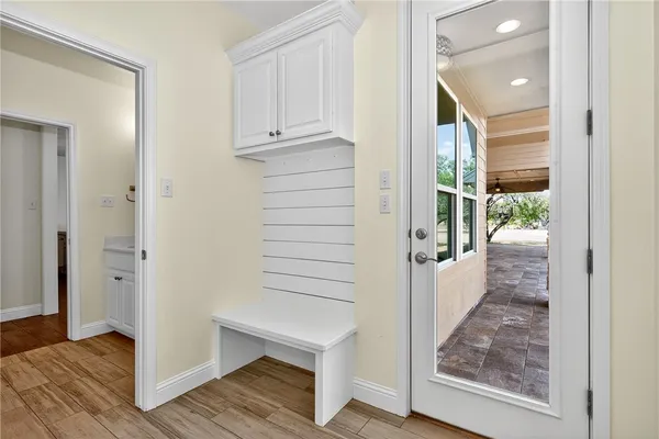 a view of a hallway with wooden floor and entryway