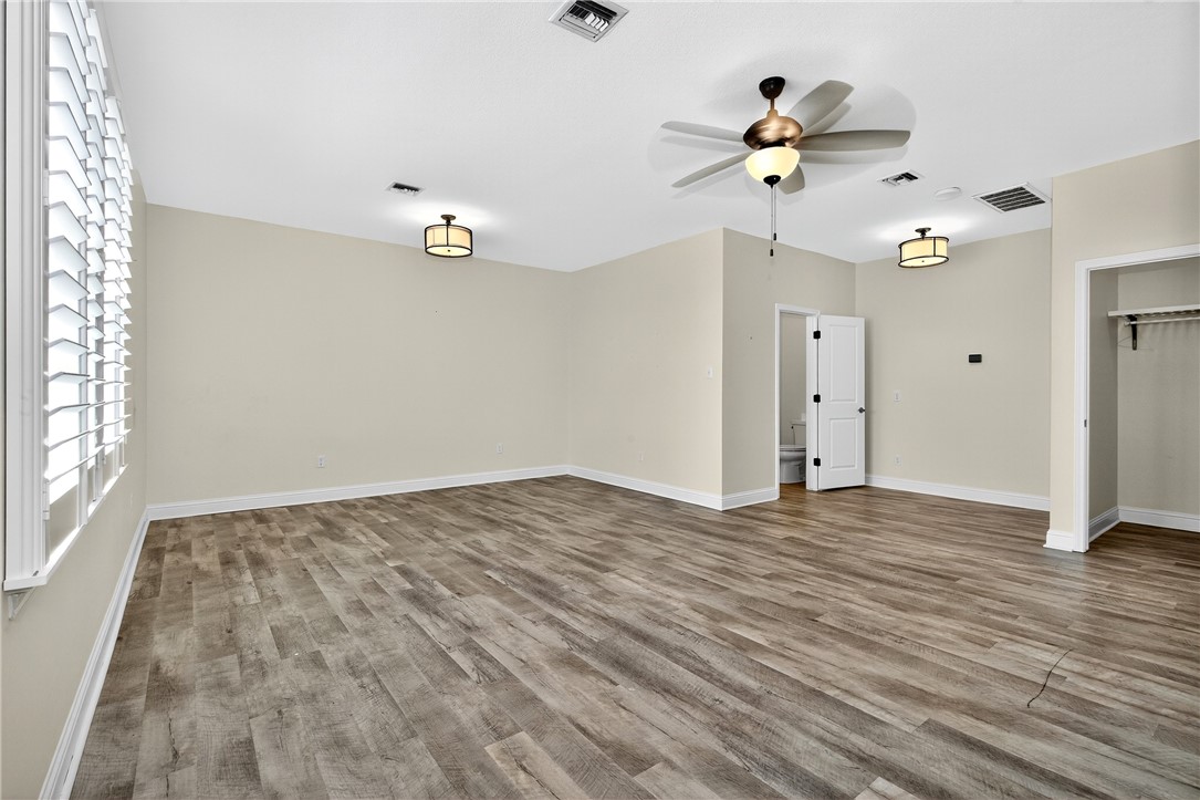 5332 Alegre Lane Robstown, TX 78380 - Photo 39 of 40 wooden floor in an empty room with a window