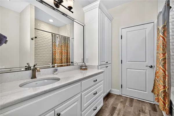 a bathroom with a double vanity sink and mirror