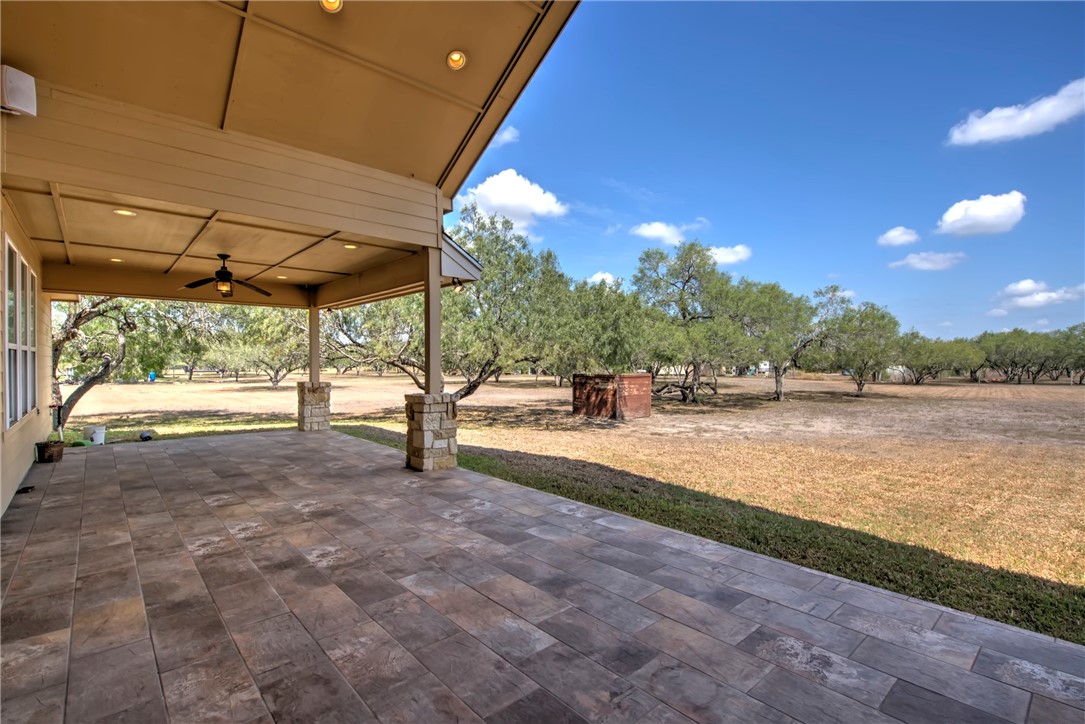 5332 Alegre Lane Robstown, TX 78380 - Photo 10 of 40 a view of a patio with a table and chairs under an umbrella