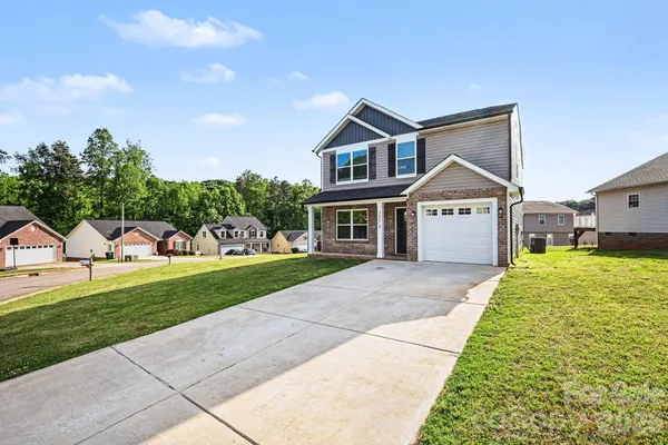 a front view of a house with a yard