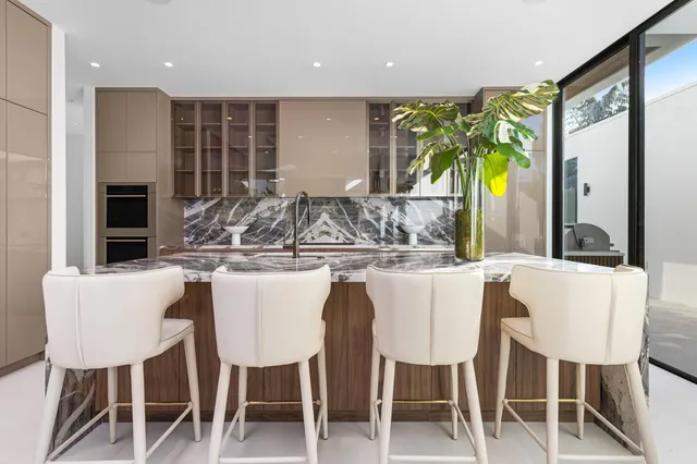 a kitchen with stainless steel appliances granite countertop a sink and a window