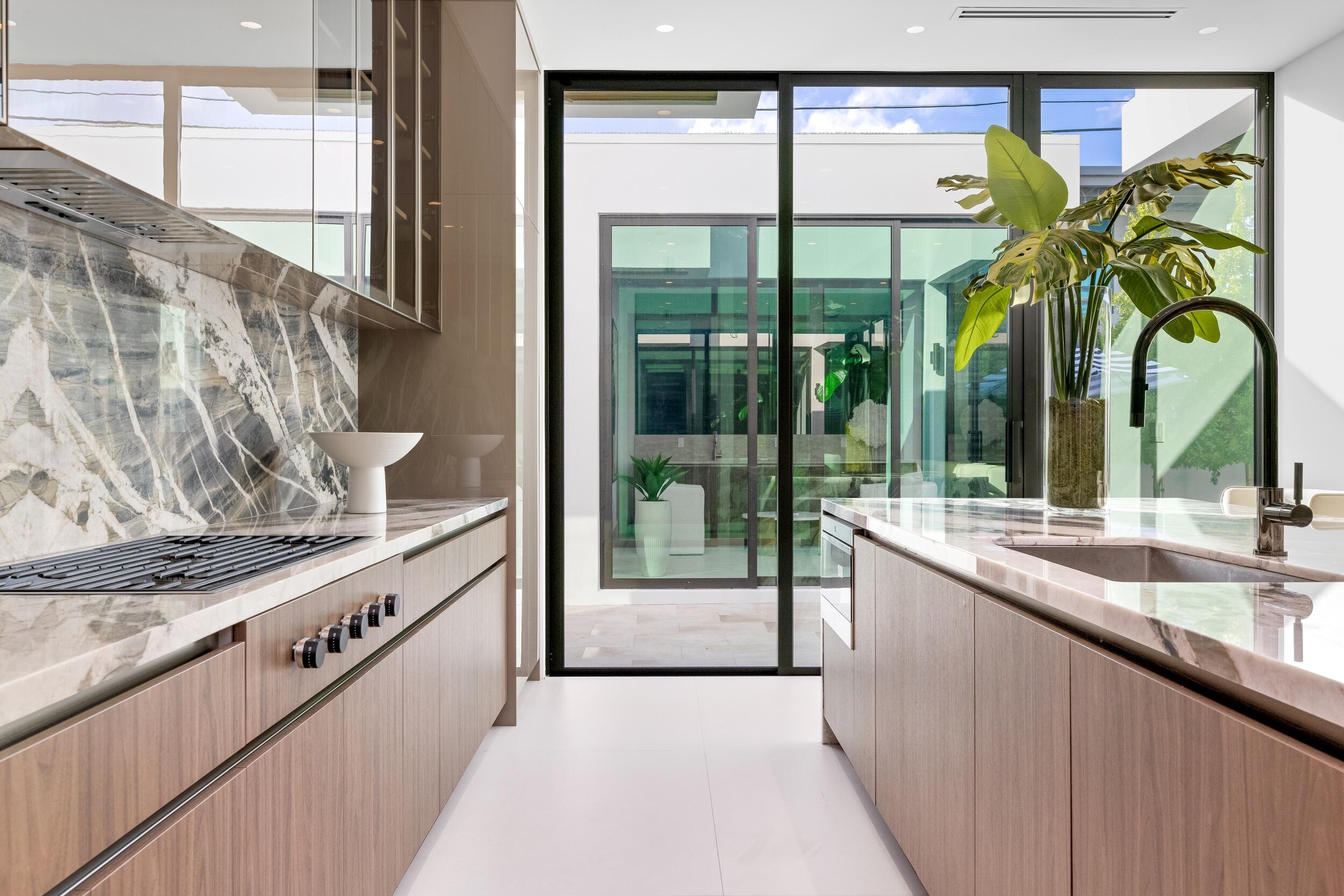 1099 Northeast 4th Avenue Boca Raton, FL 33432 - Photo 16 of 60 a kitchen with stainless steel appliances granite countertop a sink and a window