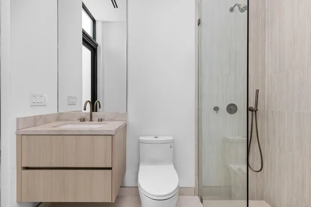 a bathroom with a tub shower and sink