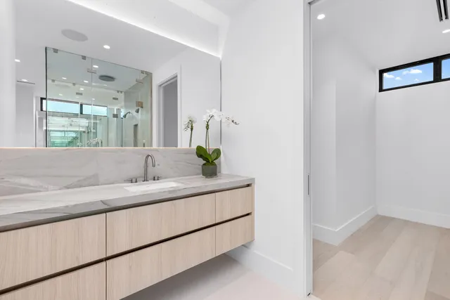 a living room with furniture potted plant and a large window