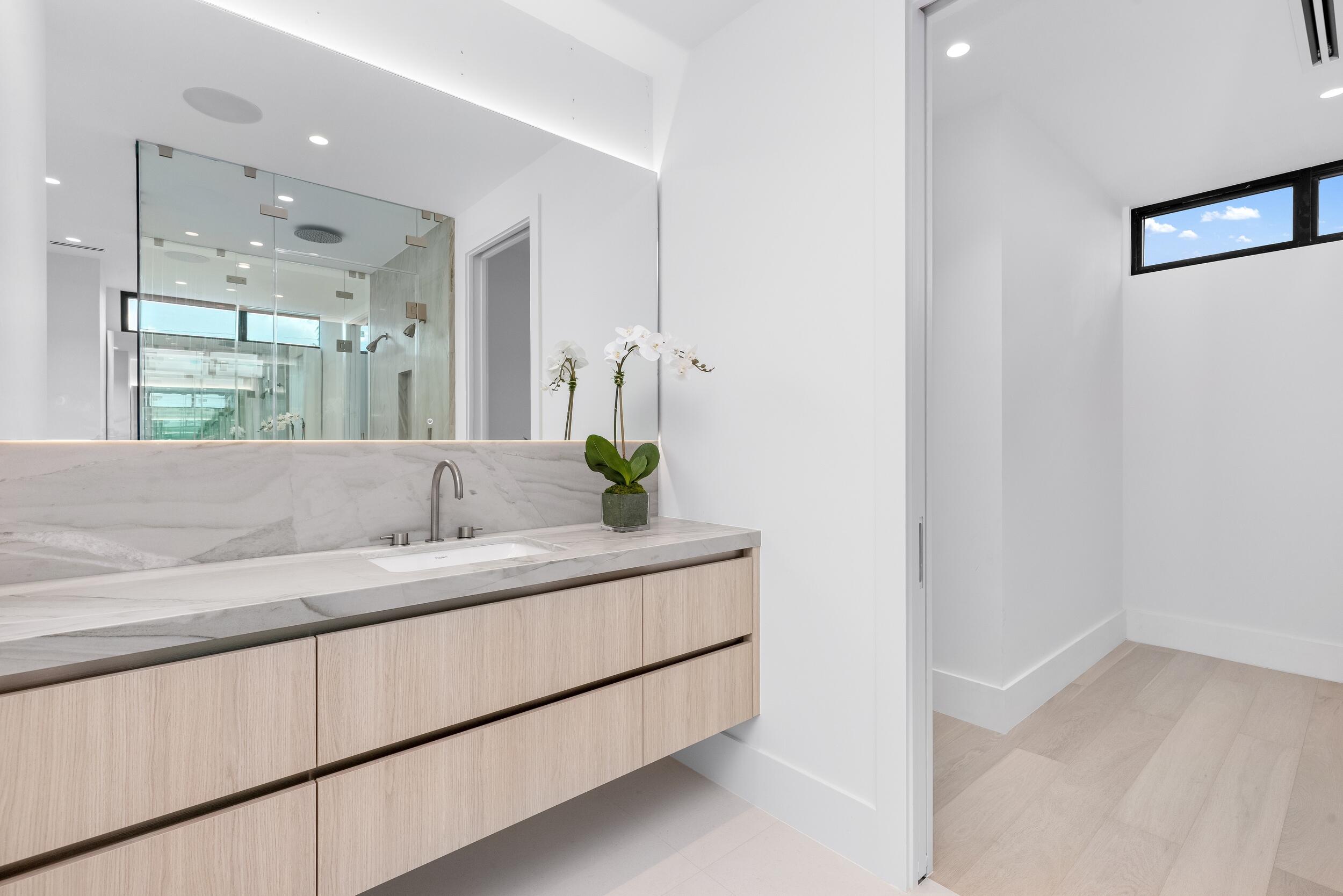 1099 Northeast 4th Avenue Boca Raton, FL 33432 - Photo 31 of 60 a bathroom with a sink and a mirror