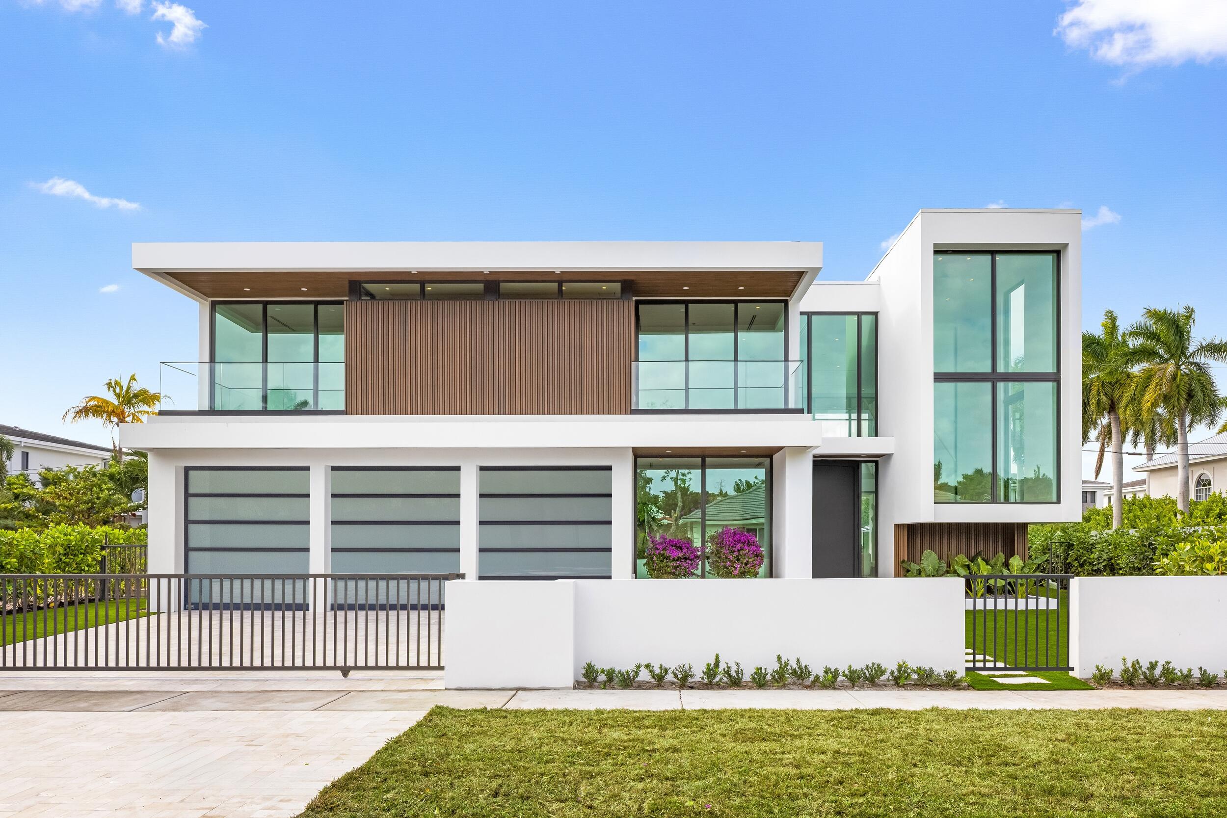 1099 Northeast 4th Avenue Boca Raton, FL 33432 - Photo 5 of 60 a front view of a house with a yard